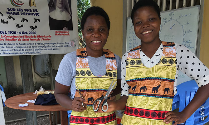 The apsirants with their new aprons - learning how to sew.