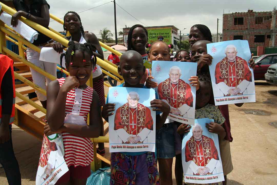 Saudação do Papa em uma de suas muitas viagens – aqui em 2009 em Luanda, Angola.