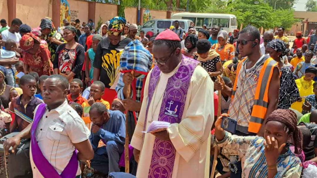 Bishop Matthew Kuka is praying with faithful in his diocese