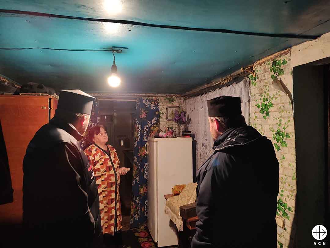 The bishop visits families living in difficult areas, bringing food and support